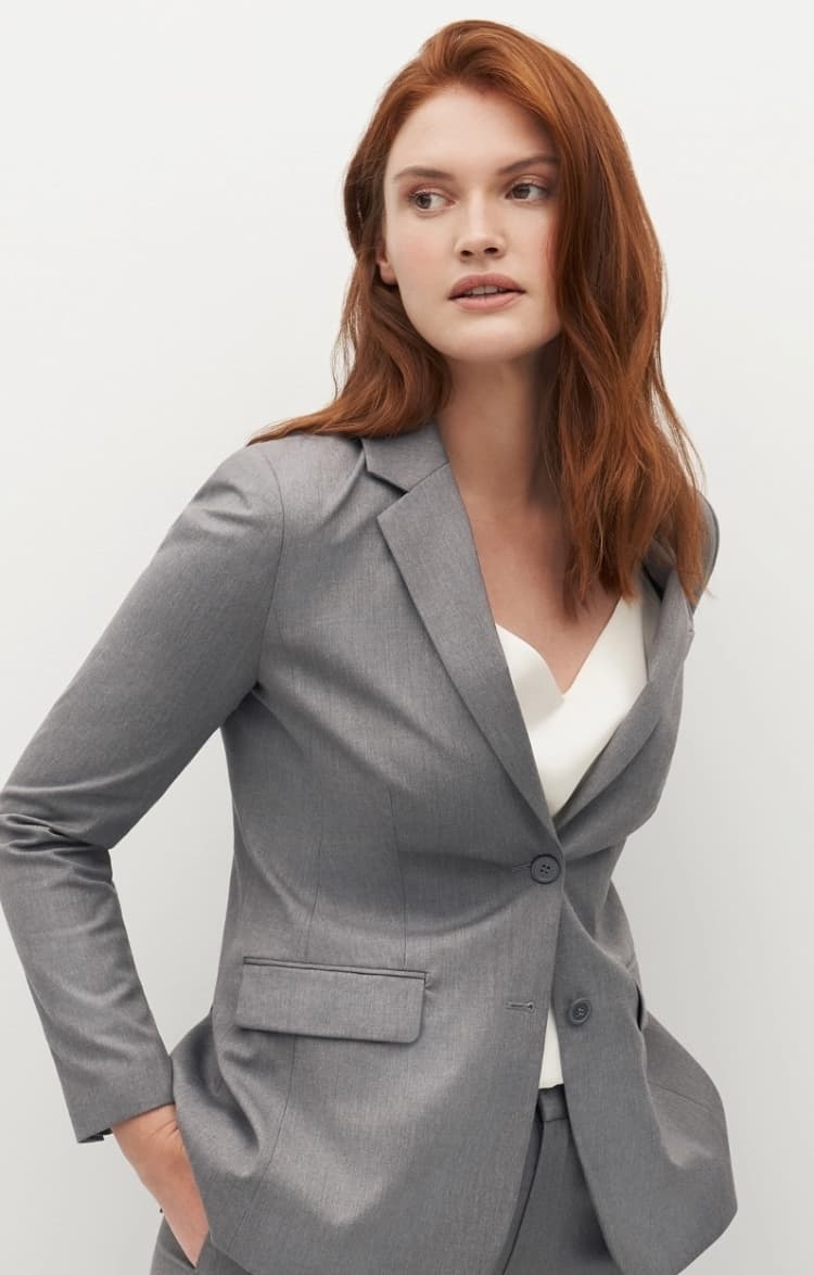 Women's light grey pantsuit with white tank top.