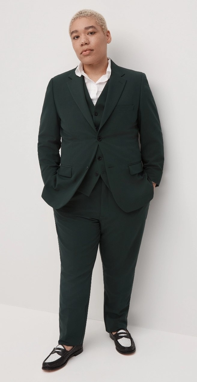 Nonbinary person in genderless unisex suit in forest green for a menswear look.