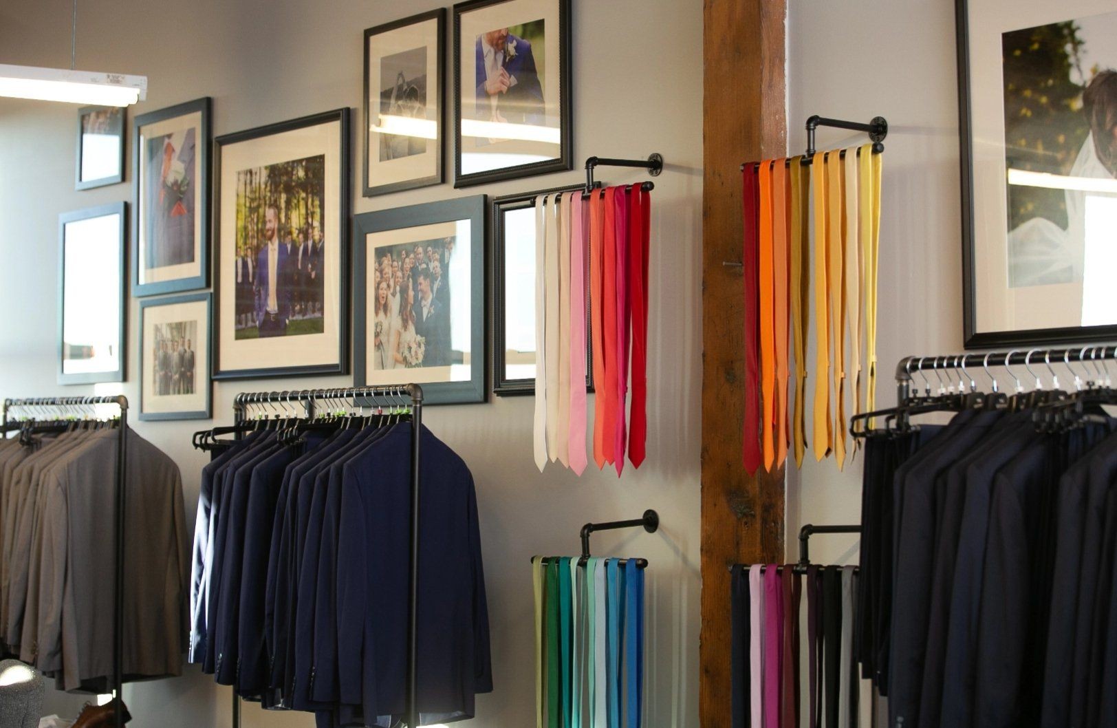 Navy blue, light grey, & royal blue suits with bright color accessories at suit store Houston showroom.