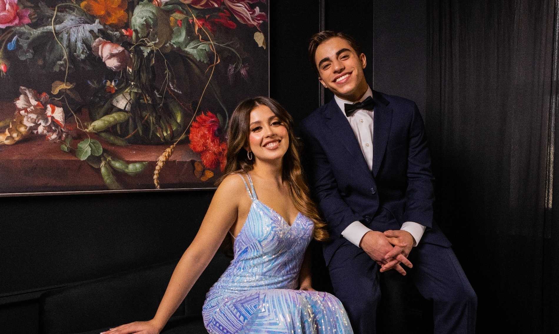 Prom date pose in light blue strappy sparkly blue prom dress & men's navy blue prom suit.