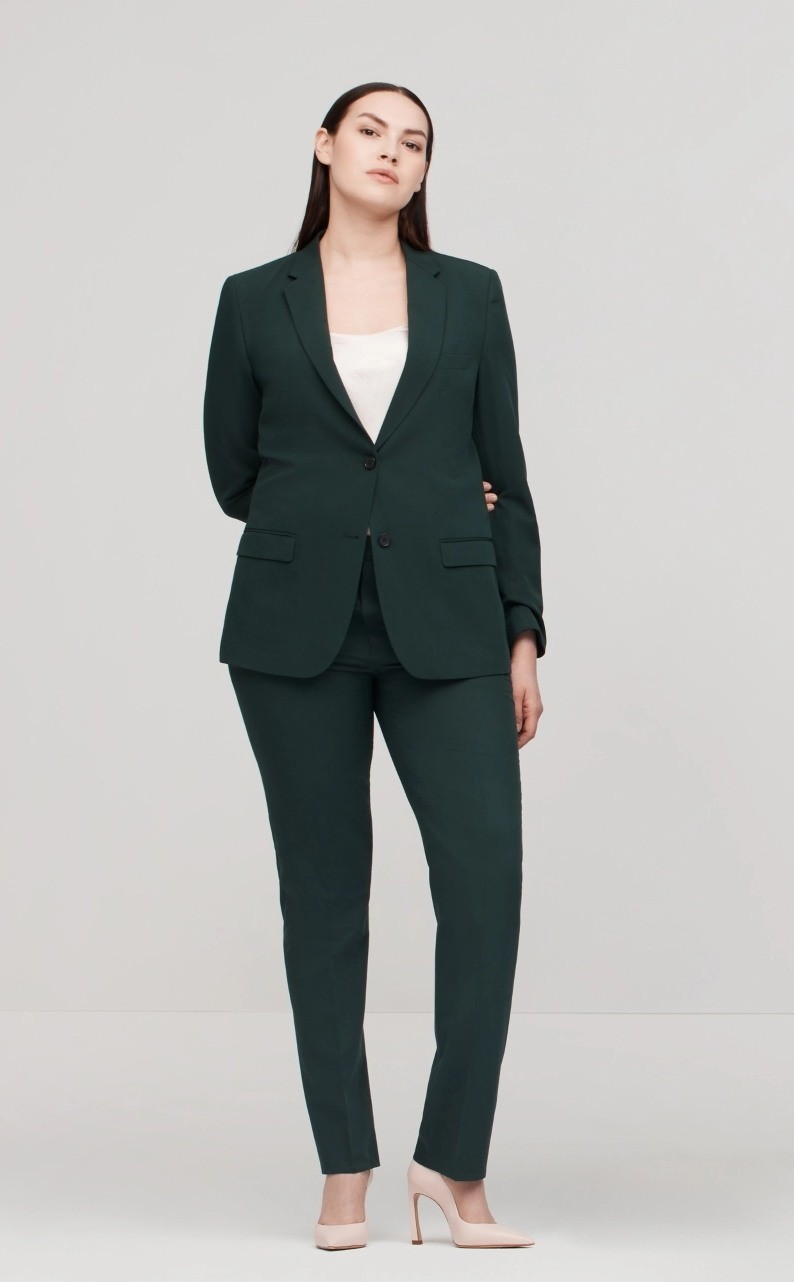 Woman wearing hunter green pantsuit in a unique, inclusive unisex cut for androgynous fit and a clean modern look.